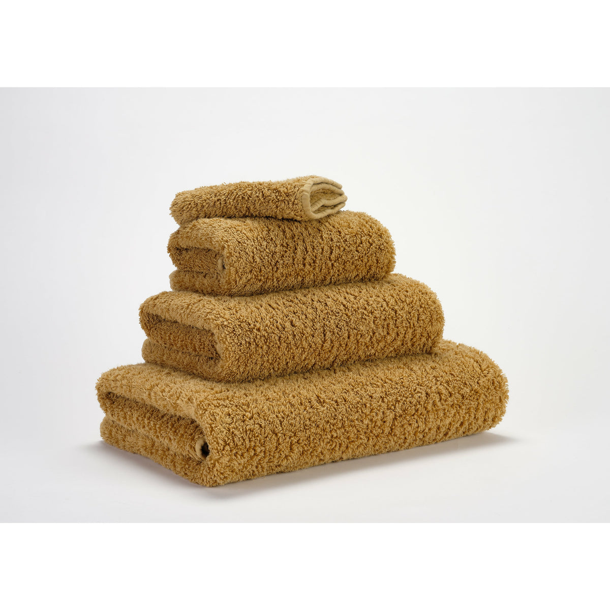 Abyss Super Pile Bath Towels Gold Fine Linens Stack Slanted