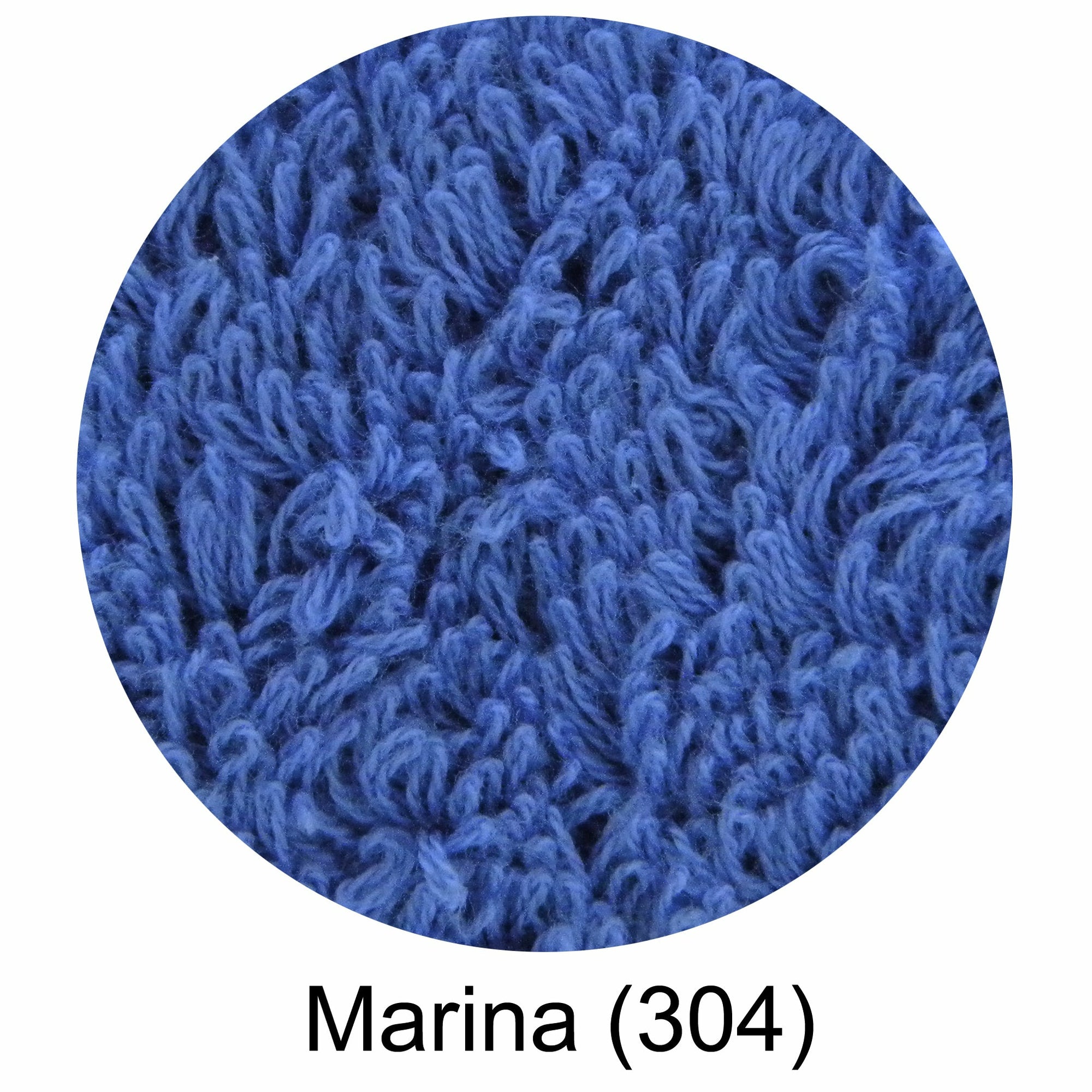 A blue Abyss Ocean Beach Towel laid out on the sand at the beach with the brand 'ABYSS' visible on the towel.