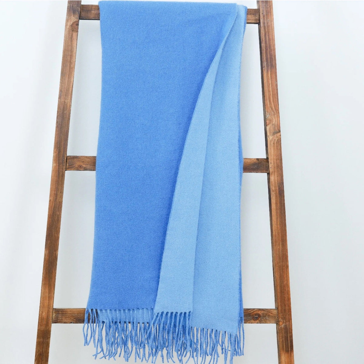 Lifestyle Image of Alashan Double Faced Classic Cashmere Blend Throw Carolina Blue/Bay Blue Color