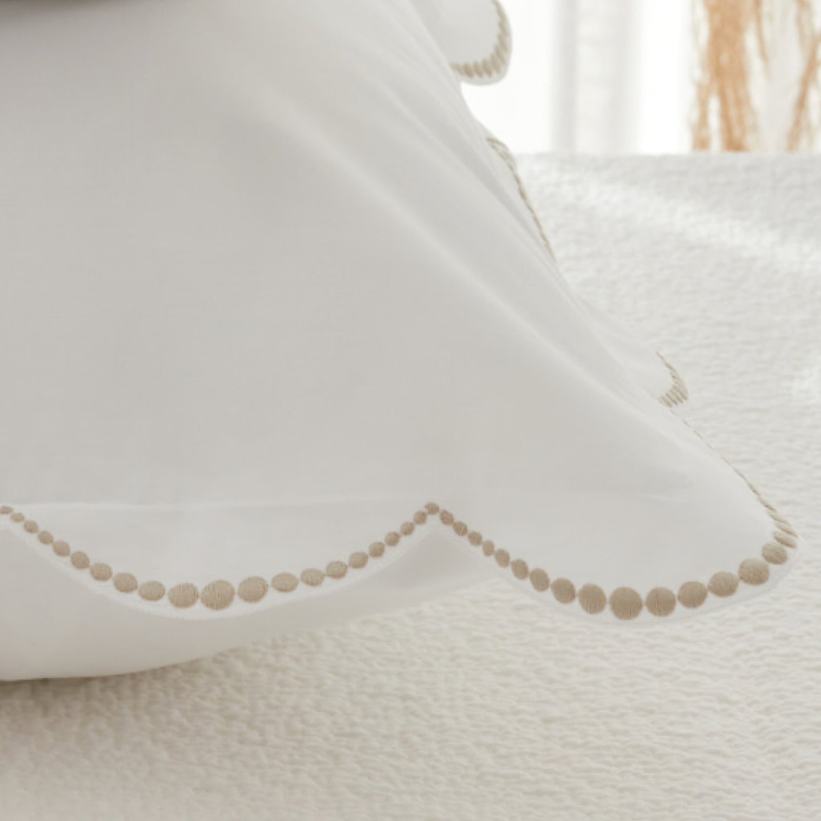 BOVI Nazare Bedding in full in a room with White and Latte Color Swatch