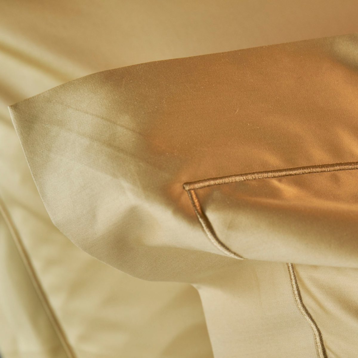 Lifestyle Shot of Gold Pillowcase of Celso de Lemos Bourdon Bedding