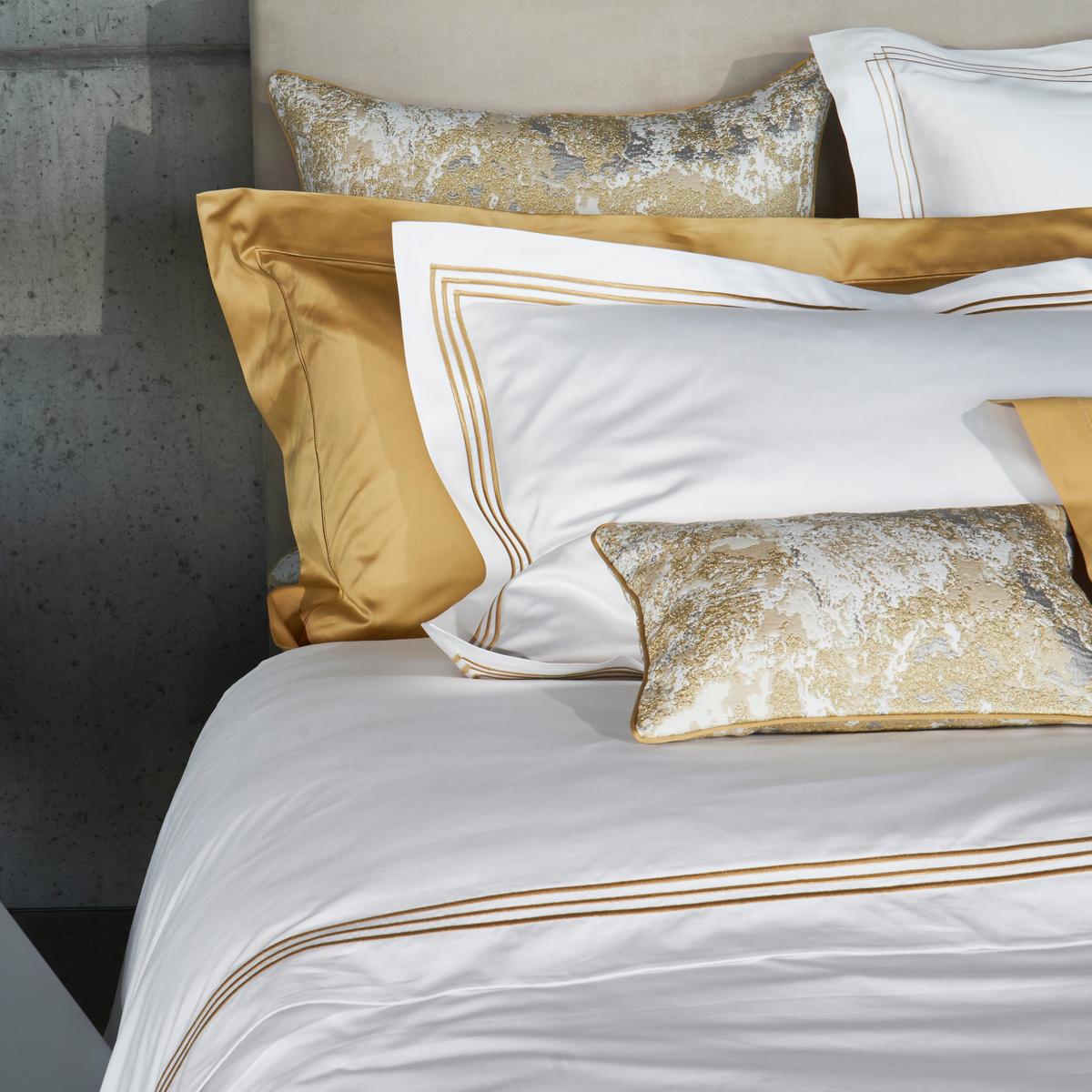 Closeup of Assorted Bedding in Gold Color with Celso de Lemos Ram Collection as Base
