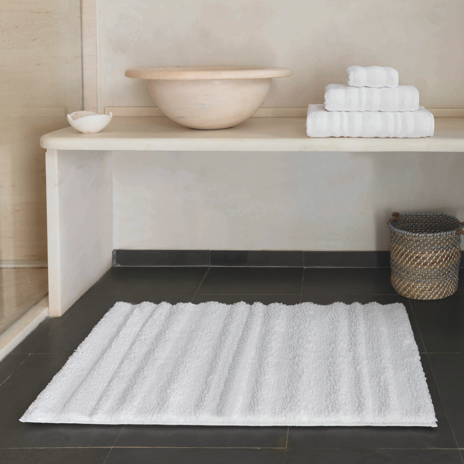 Stack of Graccioza Alentejo Bath Towels and Rug Collection in Bathroom