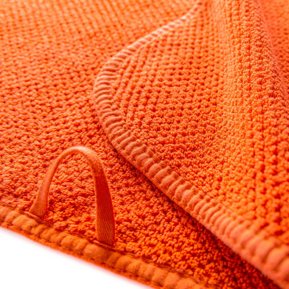 Closeup of Loop for Wall Hanging of Stack of Graccioza Bee Waffle Towels in Spicy Color