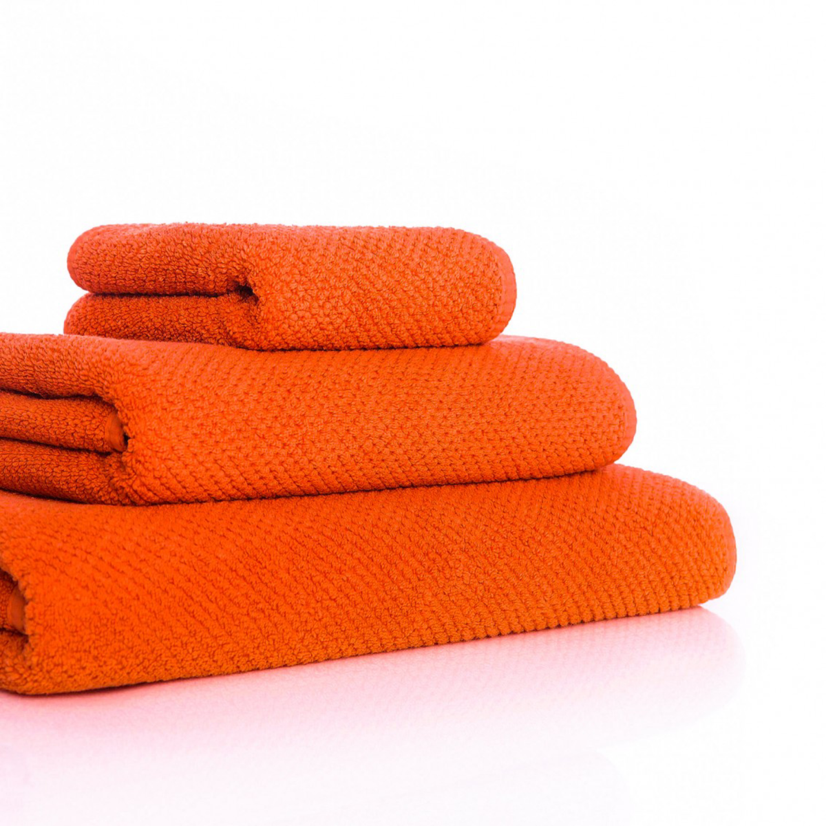 Side Angle of Stack of Graccioza Bee Waffle Towels in Spicy Color and Different Sizes