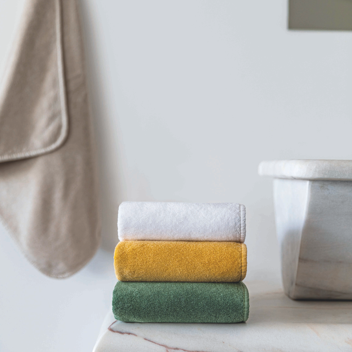 Stack of Graccioza Cool Bath Towels in Different Colors in a Bathroom