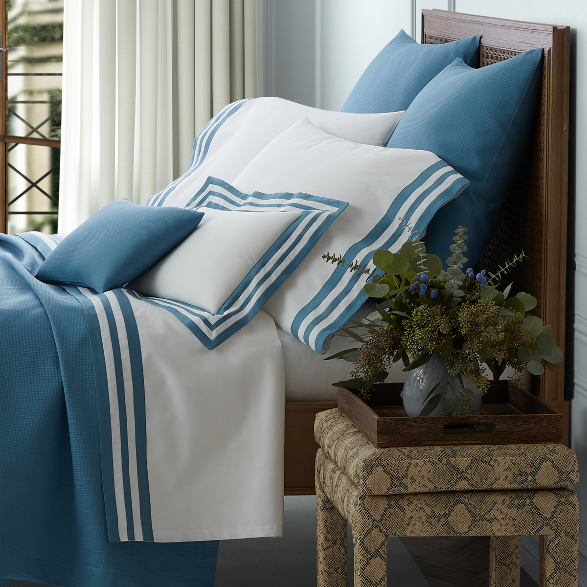 Side View of a Full Bed Dressed in Matouk Allegro Bedding in Sea Color