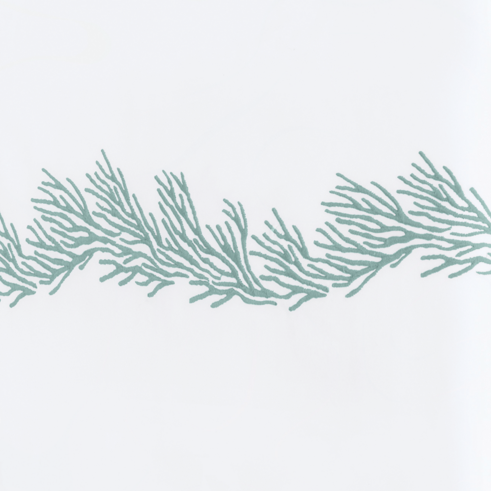 Full Lifestyle Image of Matouk Atoll Bedding Collection with Swatch of Aegean