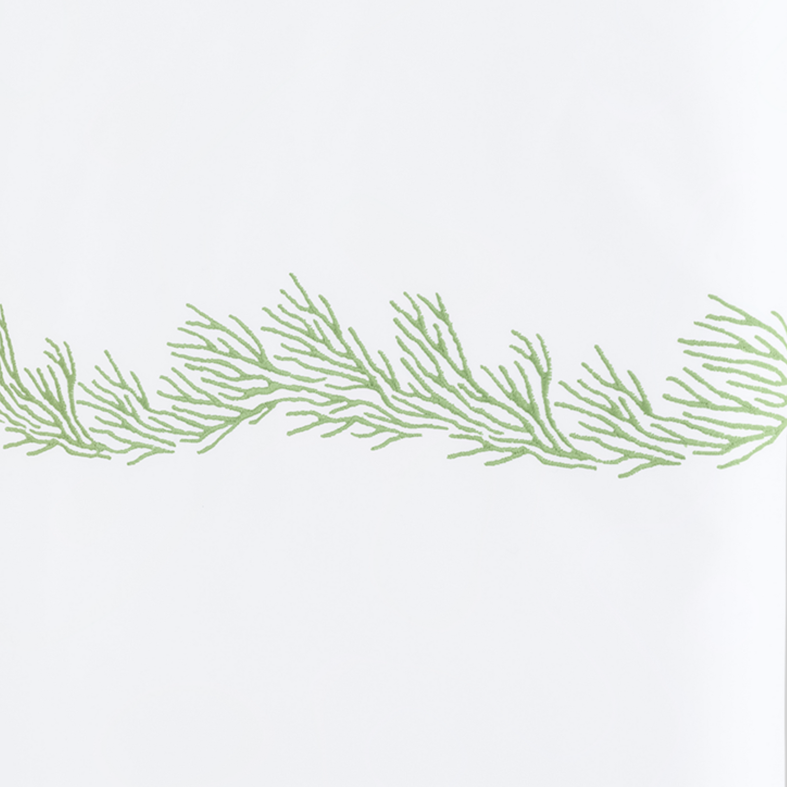 Full Lifestyle Image of Matouk Atoll Bedding Collection with Swatch of Grasshopper