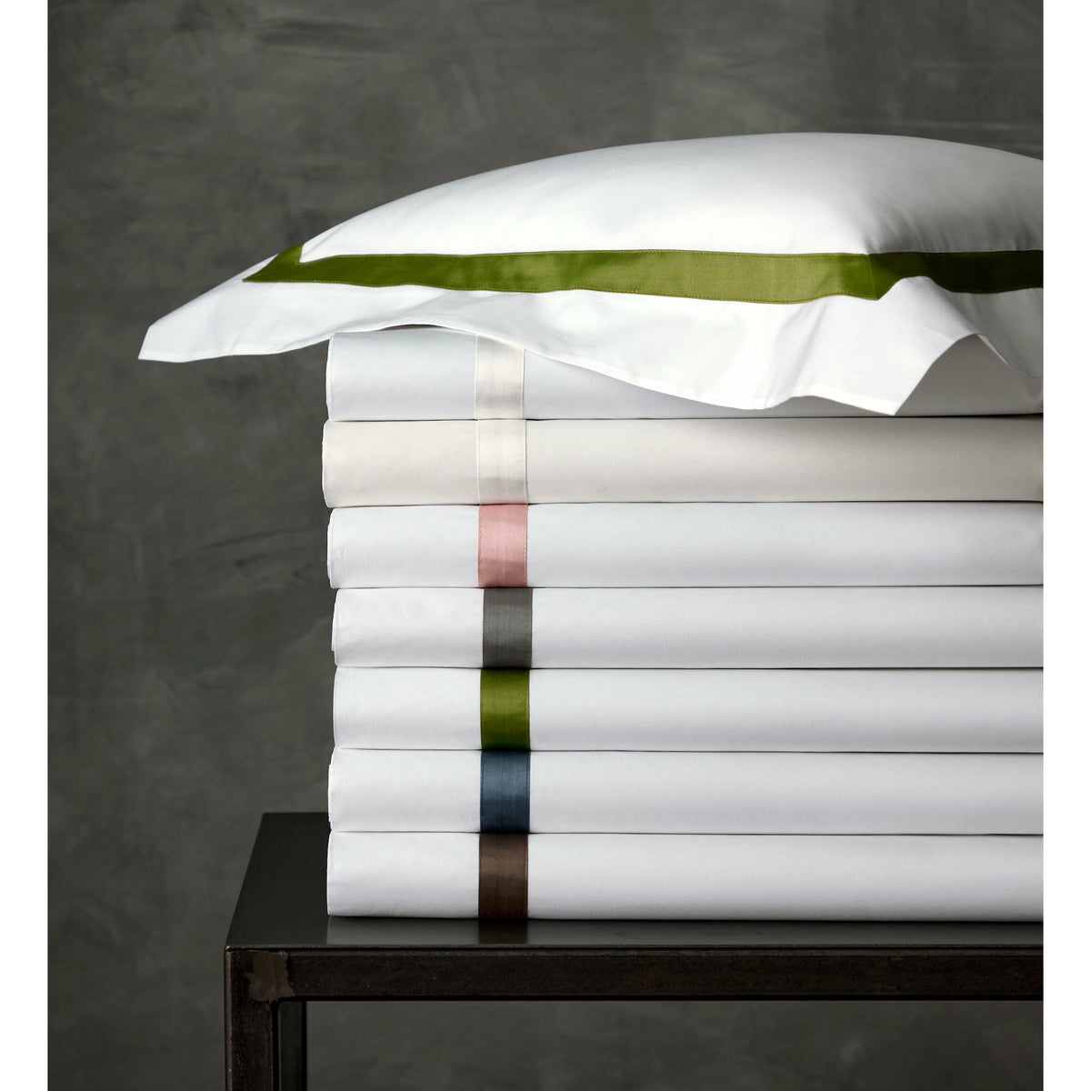 Stack of Folded Matouk Lowell Bedding Showing All Colors