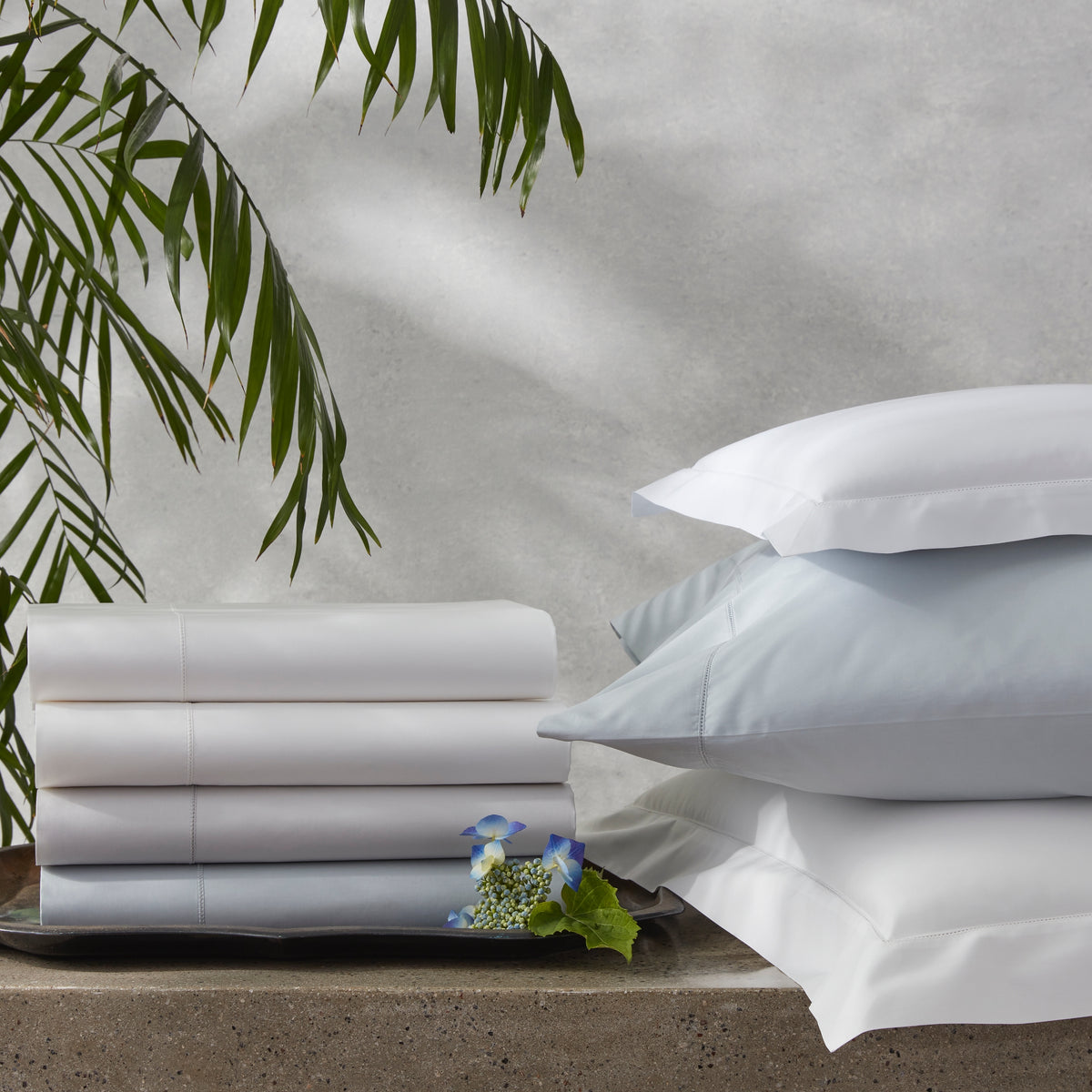 Stack of Matouk Bergamo Hemstitch Bedding Sheets and Shams all colors