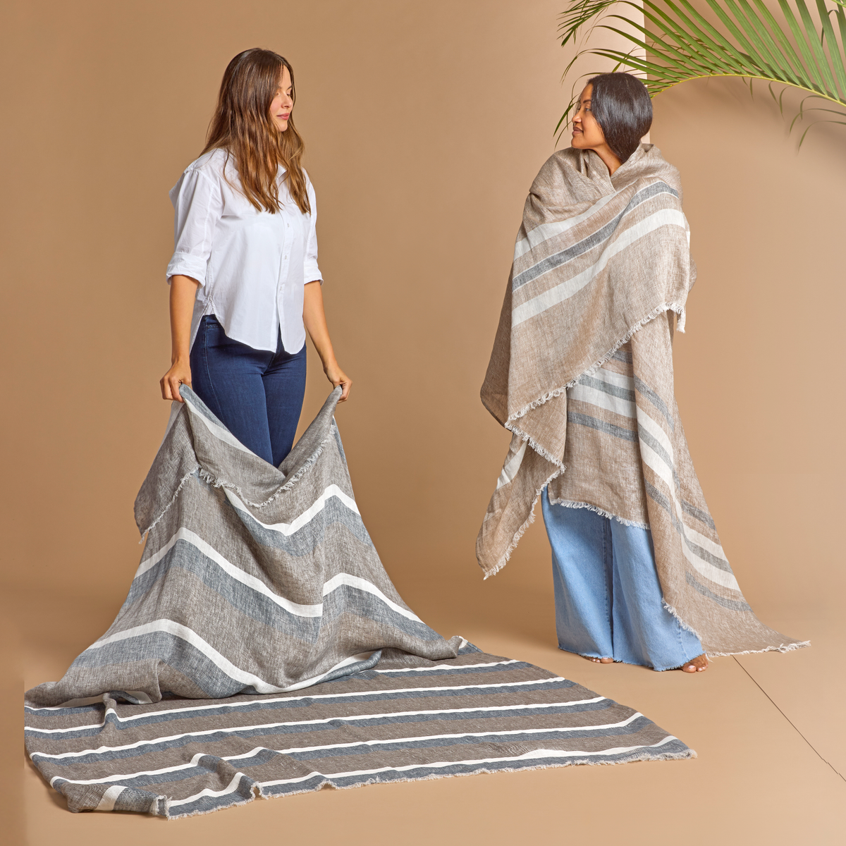 Left Model Pose with Smores Stripe Matouk Como 360 Throw looking at the other With Yosemite Stripe Color