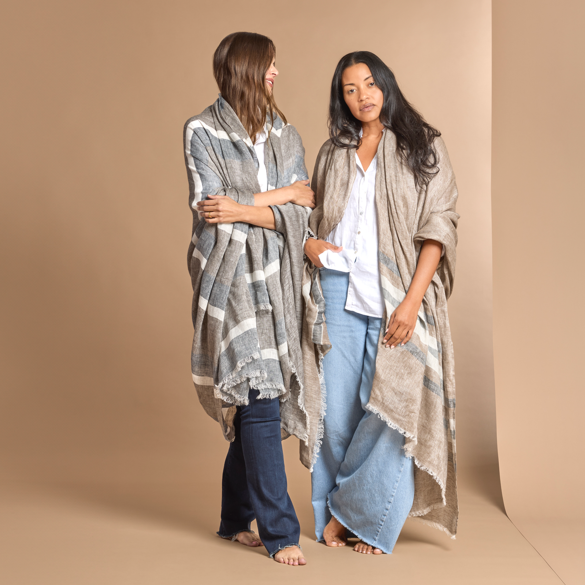 Left Model Pose with Smores Stripe Matouk Como 360 Throw another Model Wearing a Yosemite Stripe Color