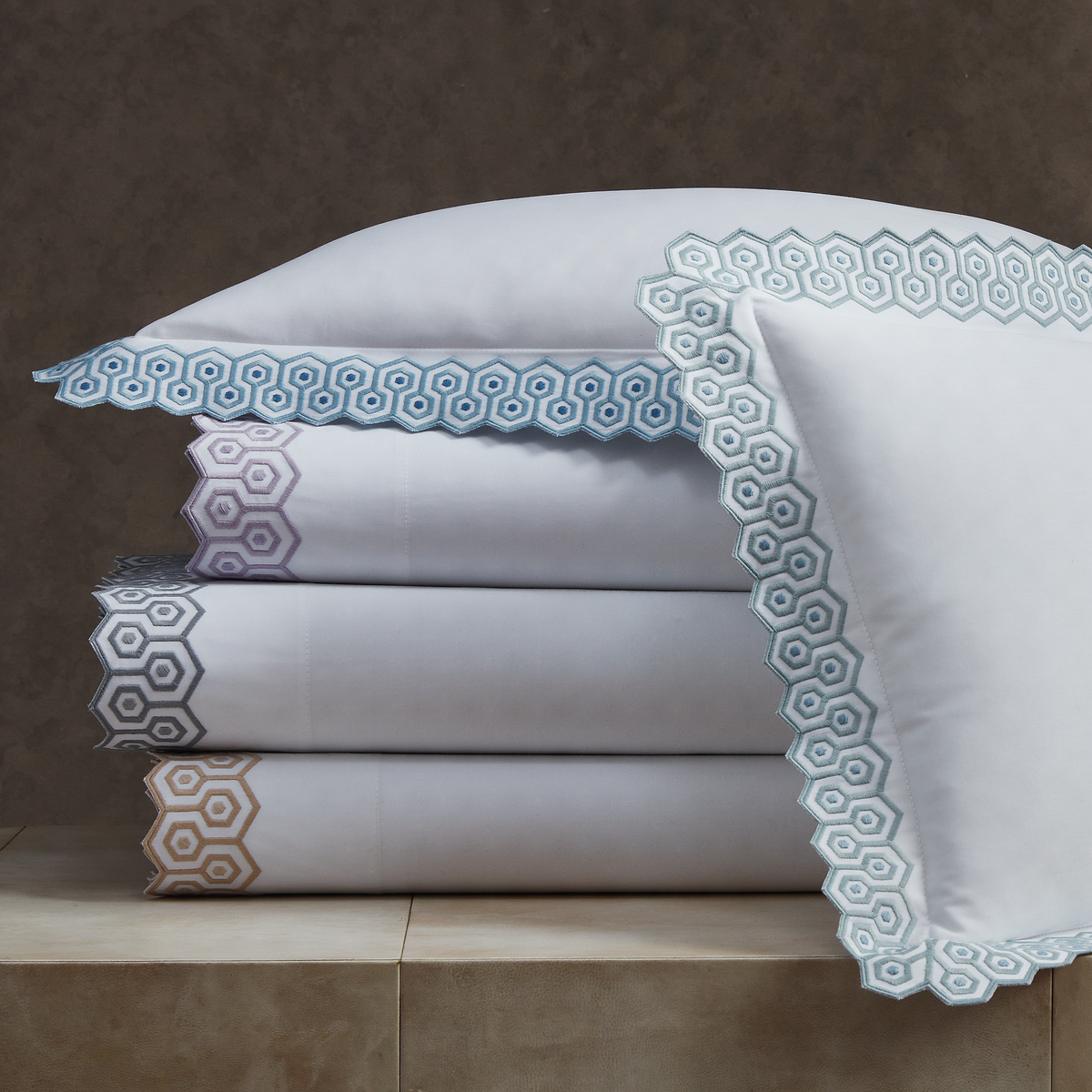 Stack of Matouk Felix Bedding in All Colors