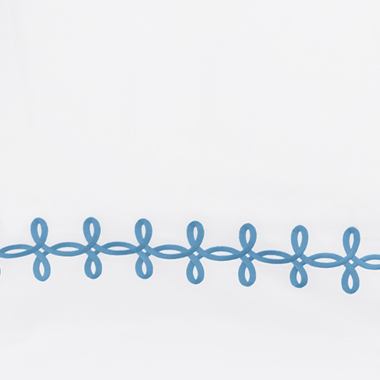 Full Lifestyle Image of Matouk Gordian Knot Bedding with Swatch of Ocean