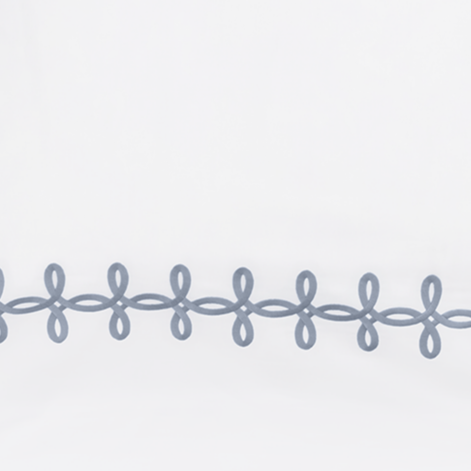 Full Lifestyle Image of Matouk Gordian Knot Bedding with Swatch of Wedgwood