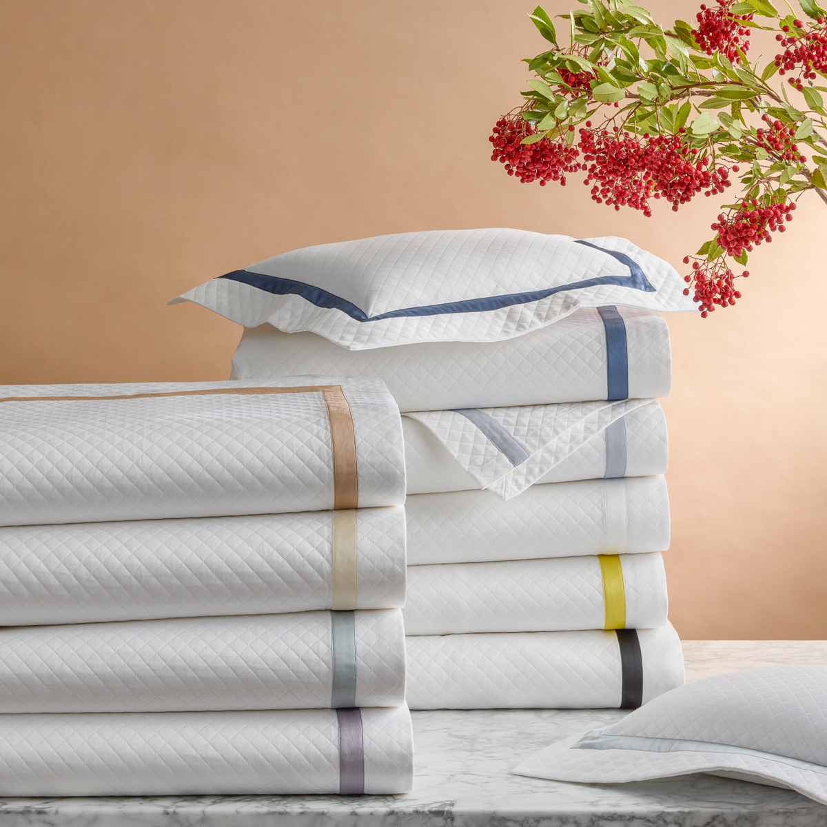 Stack of Matouk Lowell Matelassé Bedding in All Colors