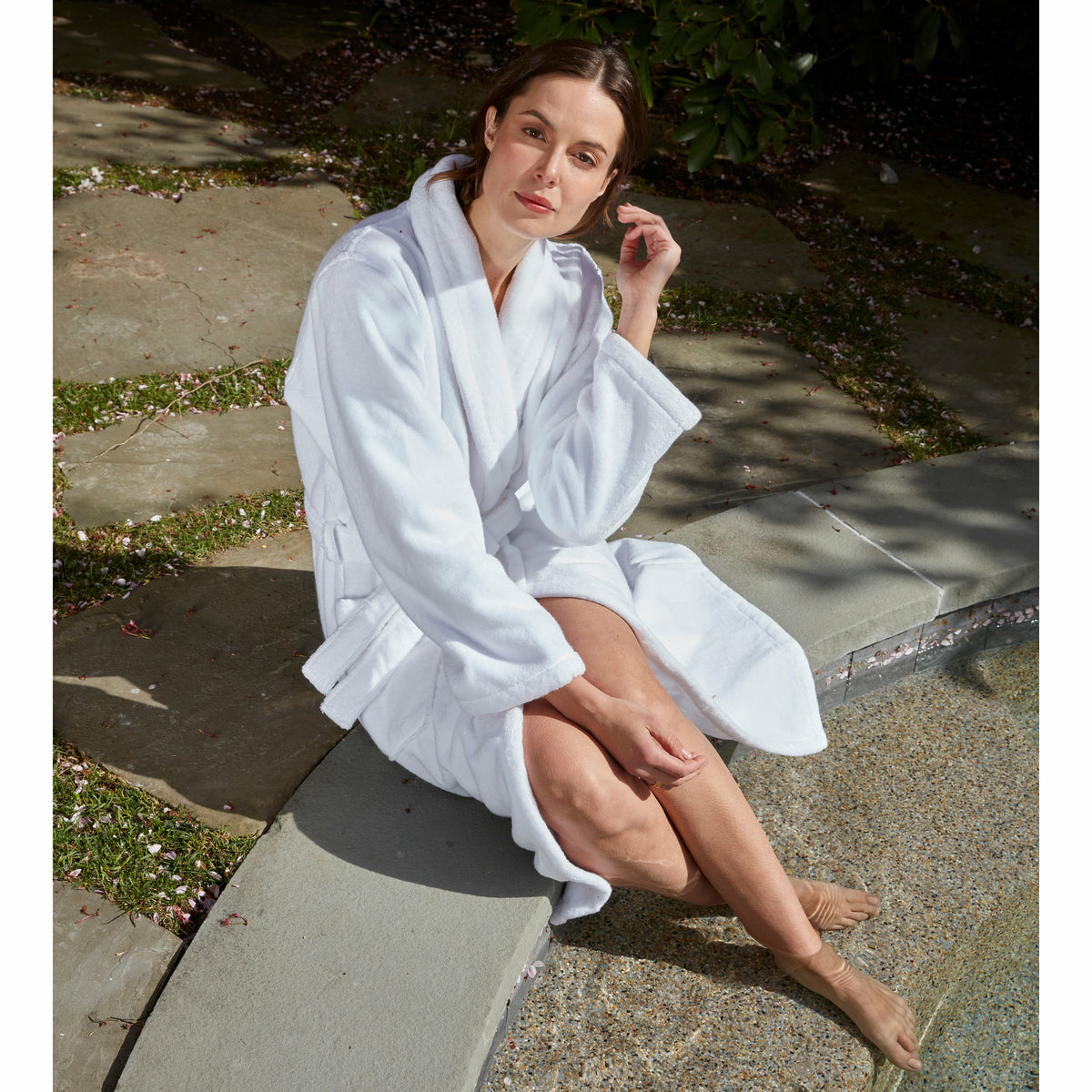 Matouk Milagro Bath Robe Lifestyle Model Sitting at Pool White