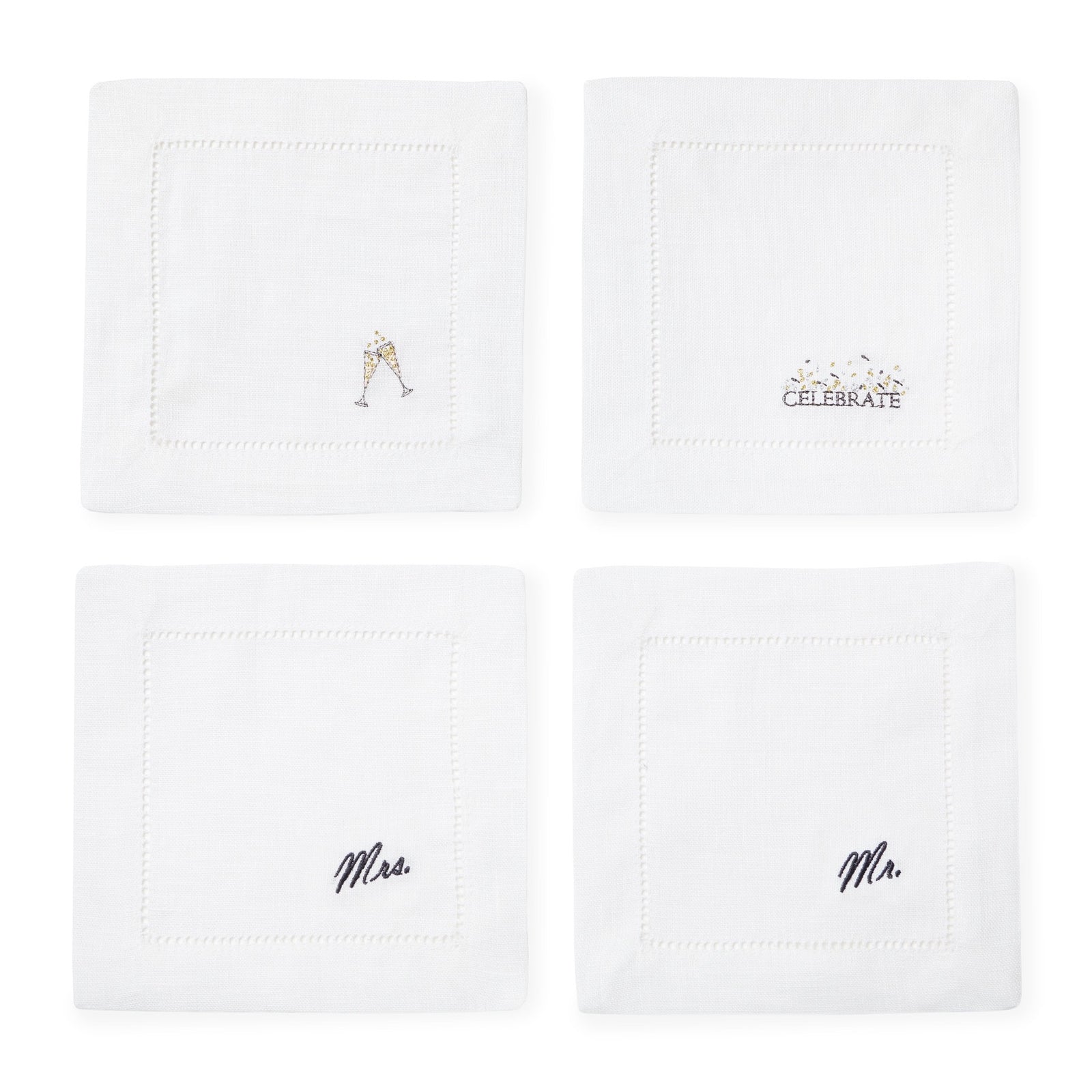 A silver tray holds two glasses of champagne, Sferra cocktail napkins, candles, flowers, and a bottle of Veuve Clicquot.