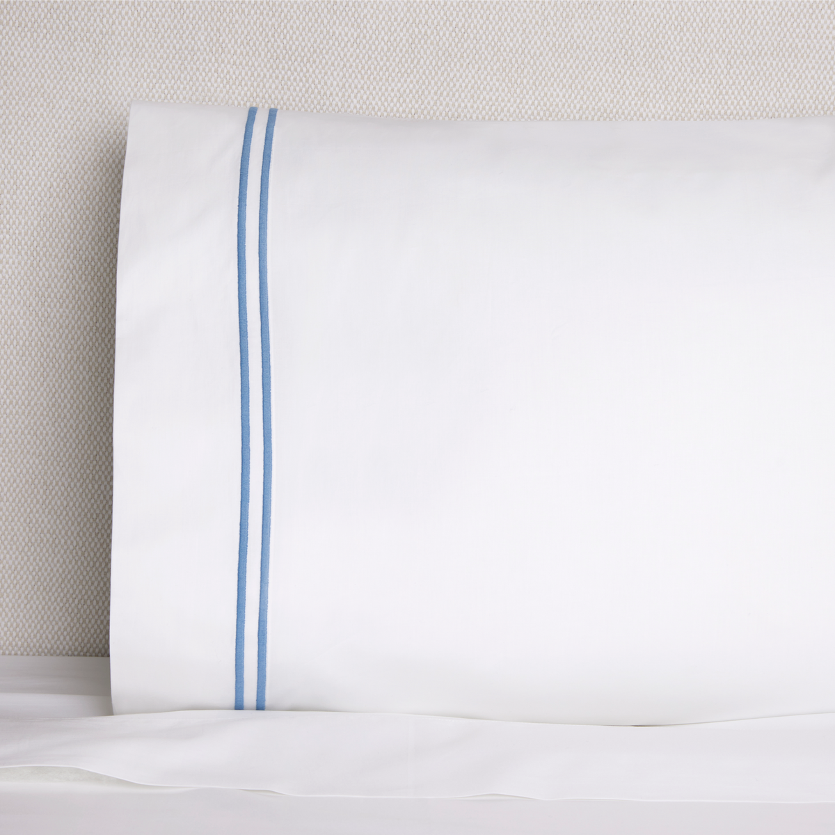 Close of Sferra Grande Hotel Collection Pillowcase on Bed White Ocean
