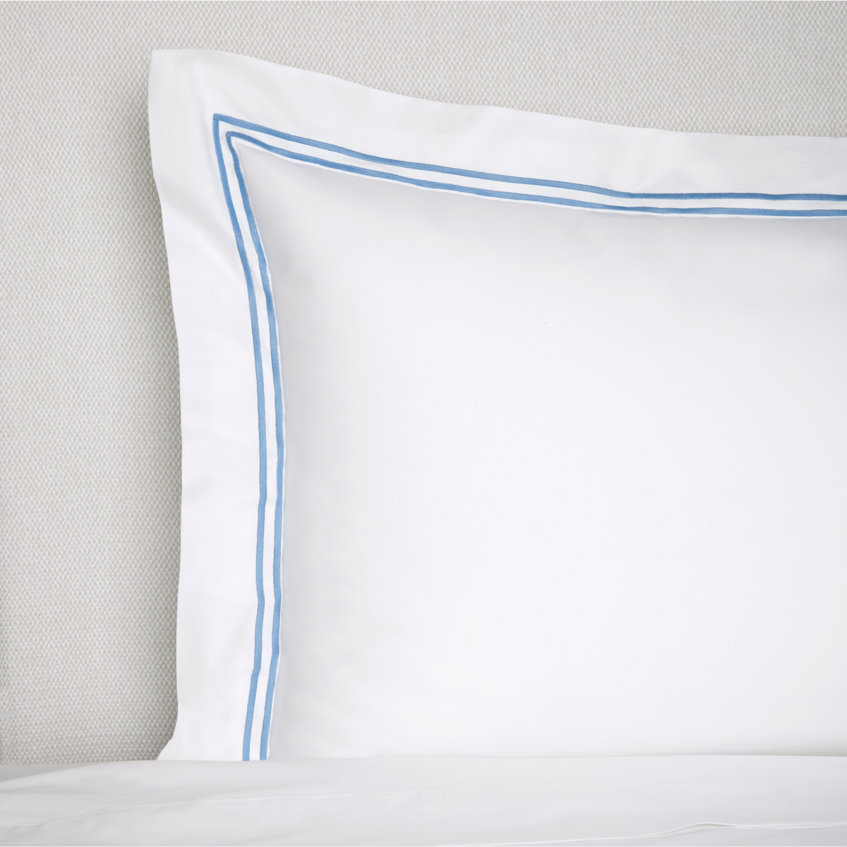 Closeup of Sferra Grande Hotel Collection Sham On Bed White Ocean
