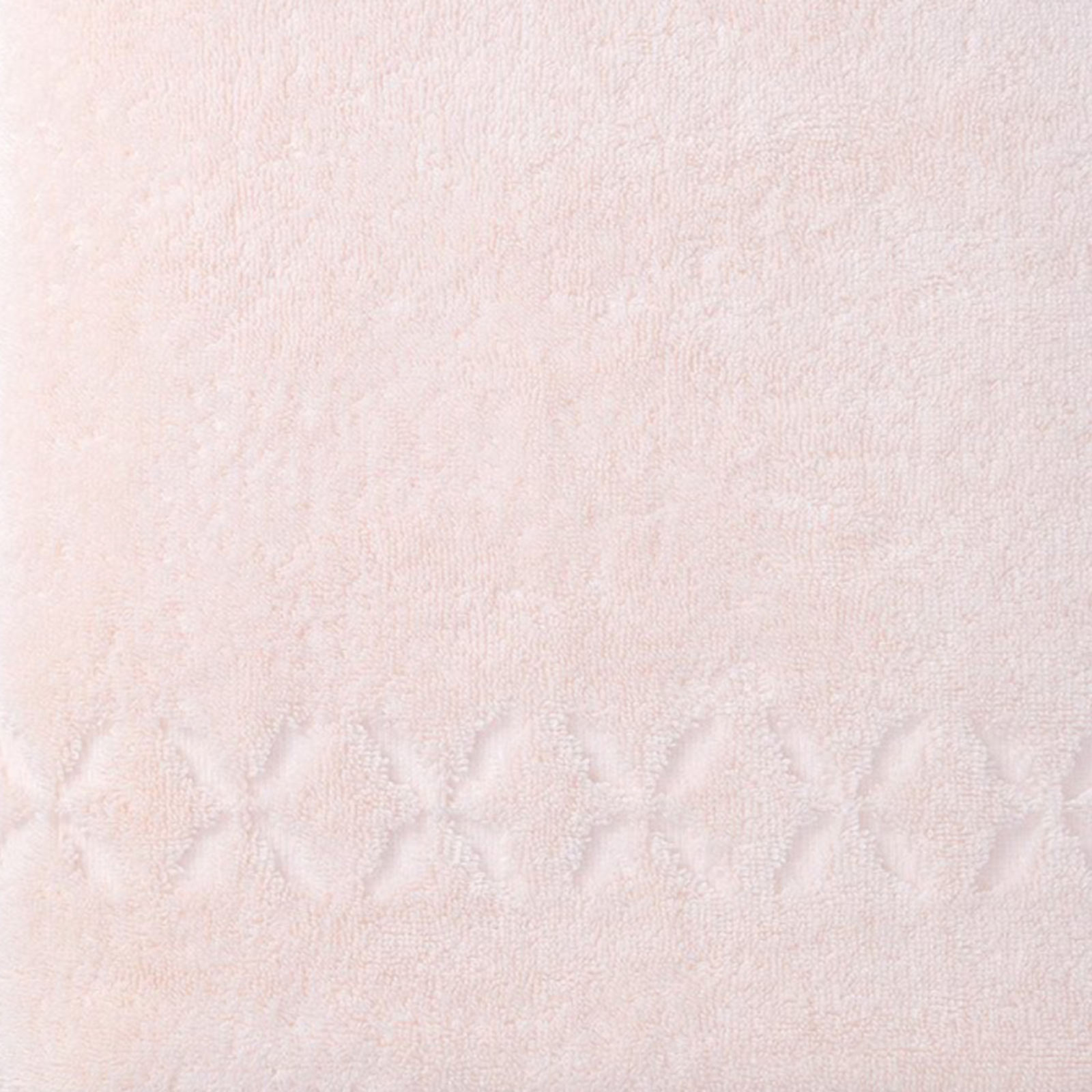 Stack of Folded Yves Delorme Nature Bath Linens in Poudre Color