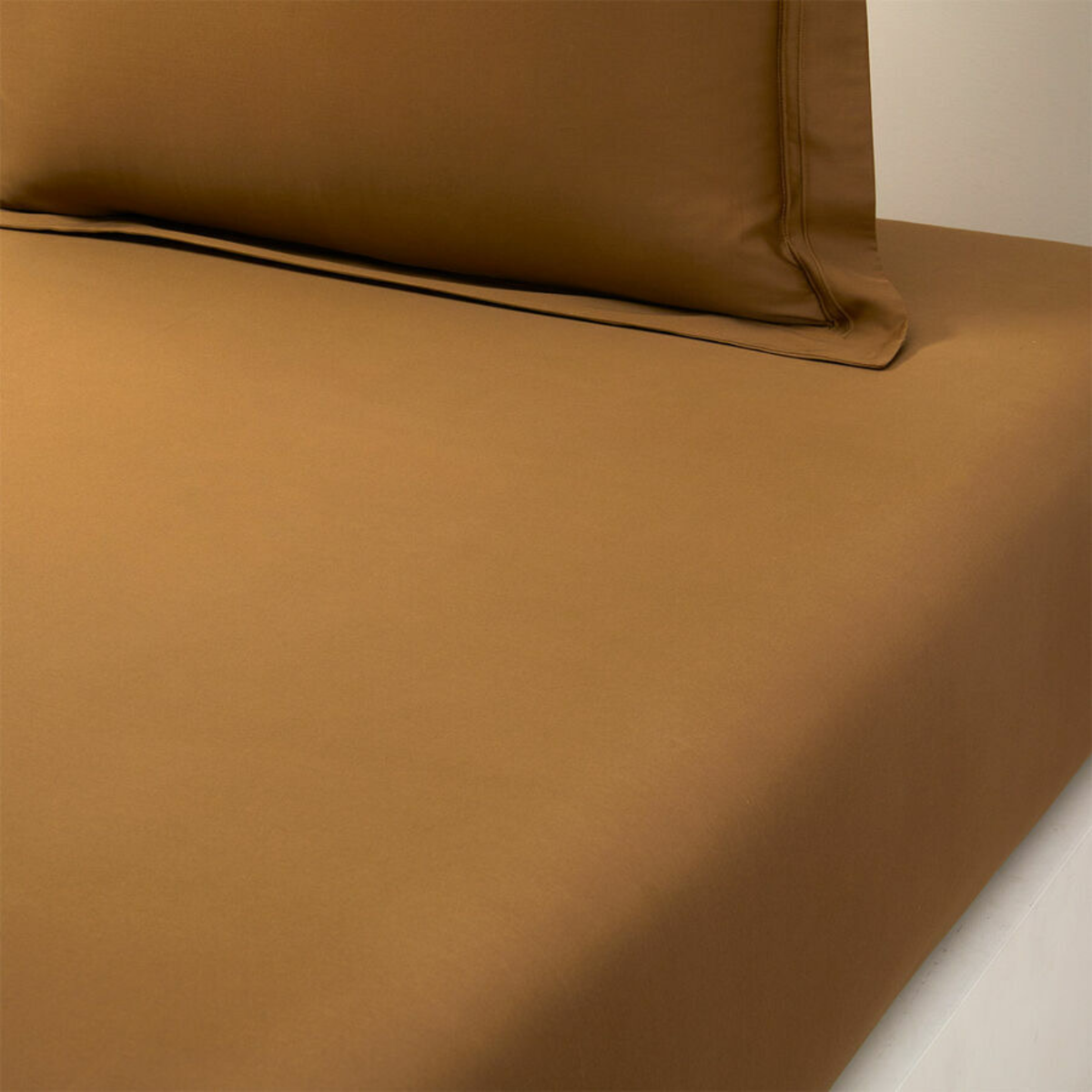 Closeup of Fitted Sheet of Yves Delorme Triomphe Bedding in Bronze Color