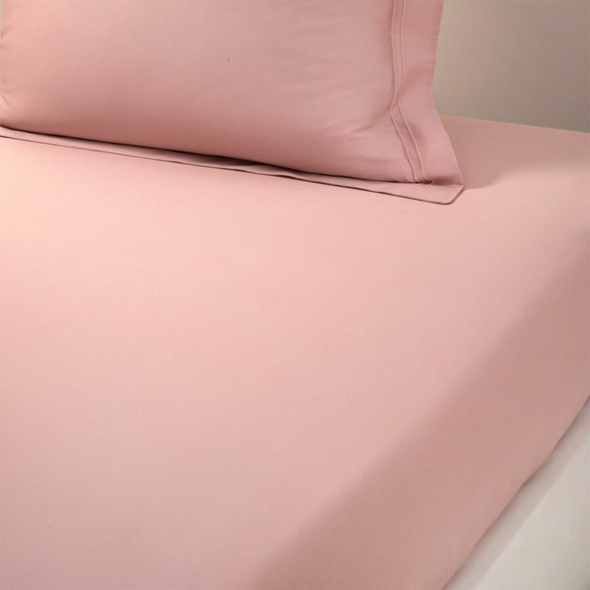 Closeup of Fitted Sheet of Yves Delorme Triomphe Bedding in Poudre Color