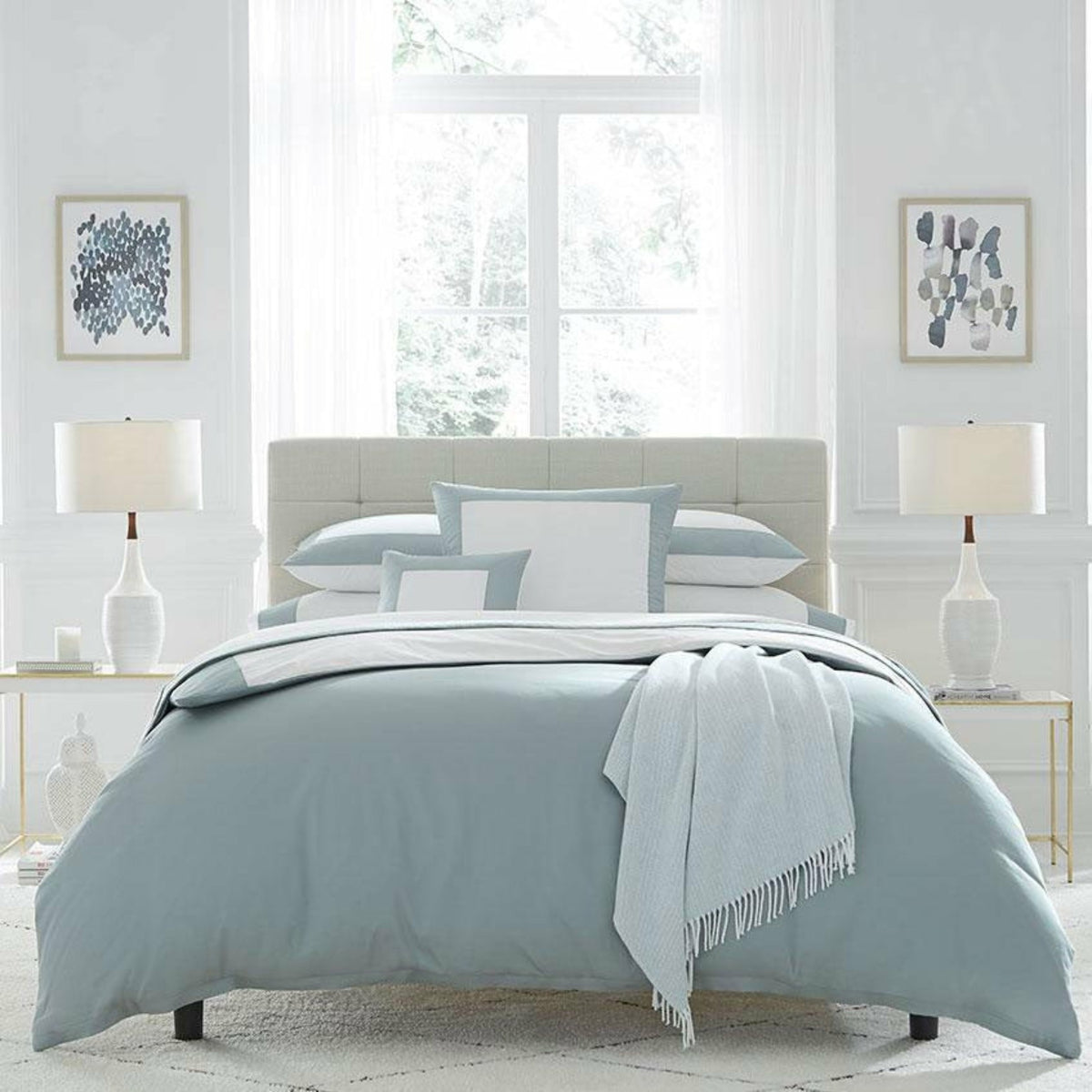 Full Lifestyle Image of Sferra Casida Bedding in Color White/Seagreen